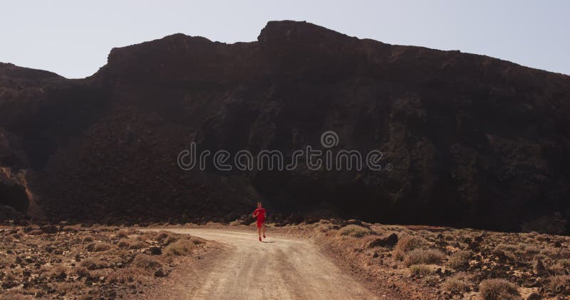 Runner running on desert road sprinting fast in compression running clothing