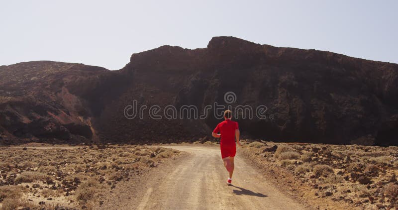 Running man - runner desert road sprinting fast in compression running clothing