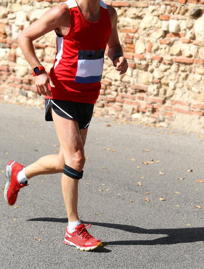 Runner Runs with a Band Below the Knee Stock Photo - Image of legs ...