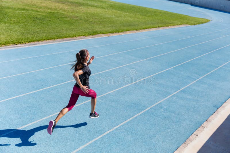 Runner sprinting towards success on running track stock photos Runner sprinting towards success on running track stock photos
