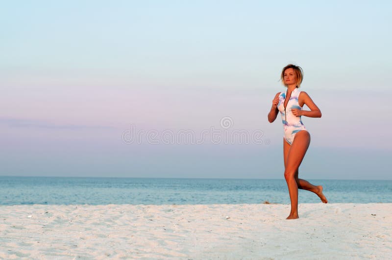 Runner woman running in the beach at sunset. stock photos Runner woman running in the beach at sunset. stock photos