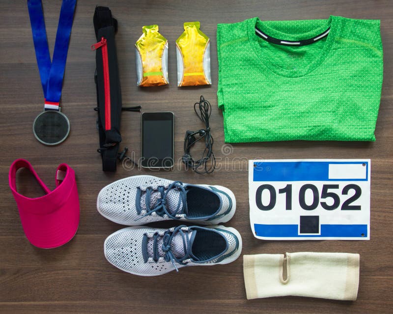 Runners Gear And Energy Gels On Wood Background