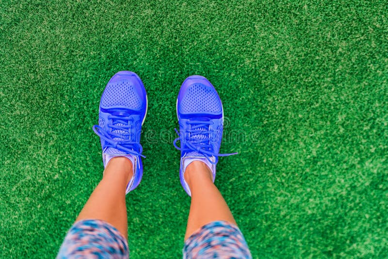 Runnin shoes POV standing selfie girl going walking doing outdoor exercise on grass for weight loss. Summer fitness lifestyle