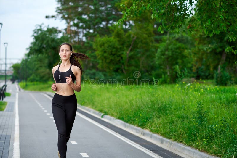 Running asian woman on running track. Morning jogging. The athlete training stock photography Running asian woman on running track. Morning jogging. The athlete training stock photography