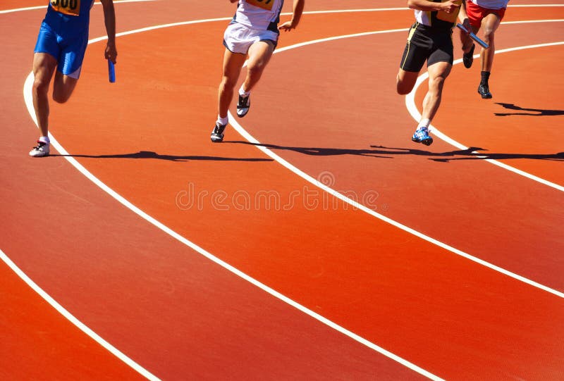 Running athletes. At stadium in relay race athletics competition stock photo