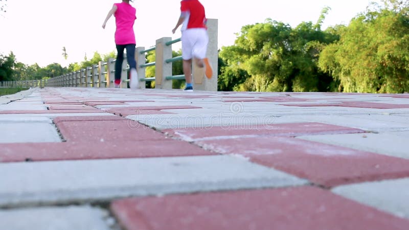 Asian children runner in sportswear jogging in public park. Healthy Lifestyle.