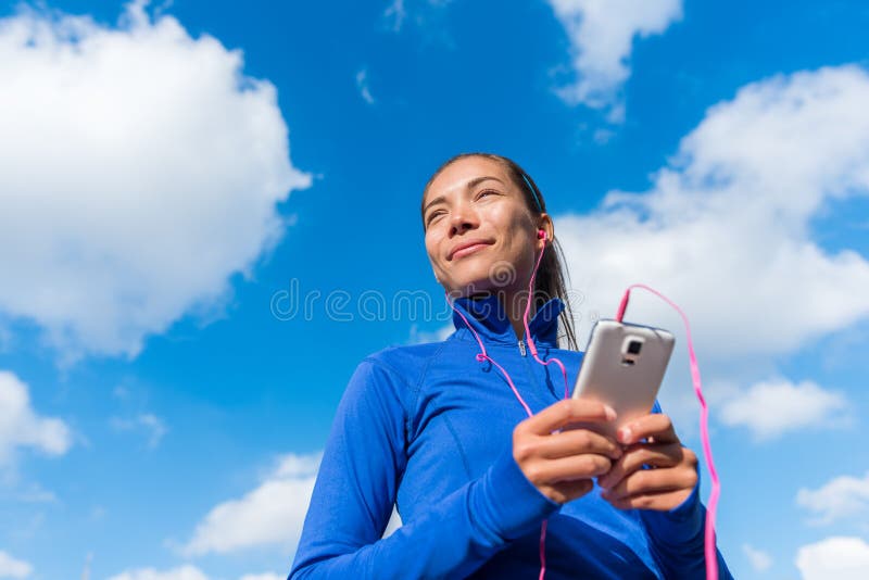 Running girl listening to music on smart phone