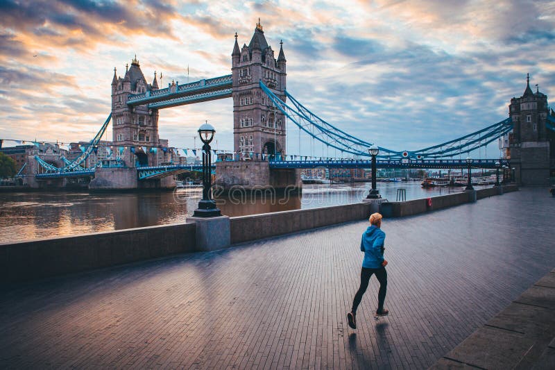 Running in London. Man train near by Tower Bridge, London, England