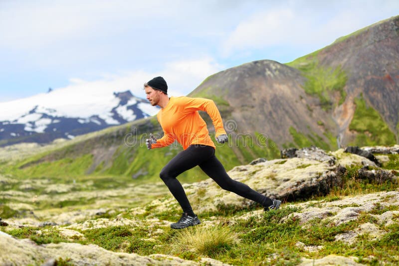 Running man in cross country trail run. Fit male runner sport training outdoors in beautiful mountain nature landscape with Snaefellsjokull, Snaefellsnes, Iceland.