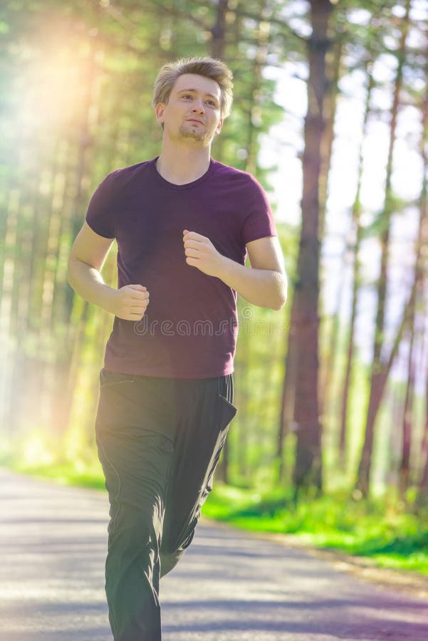 Man Jogging in City Partk at Beautiful Summer Day. Sport Fitness Model ...