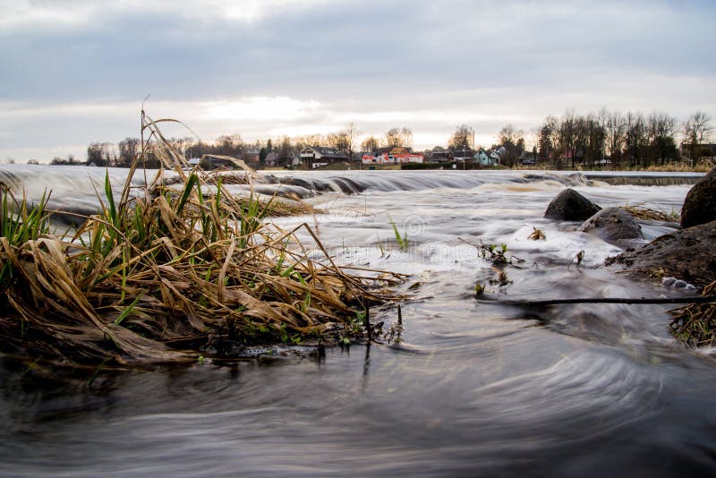 Running river with waterfall stock photo