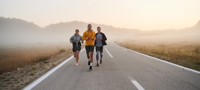 Running towards a common goal, a group of colleagues braves the misty morning air, their determination evident in every