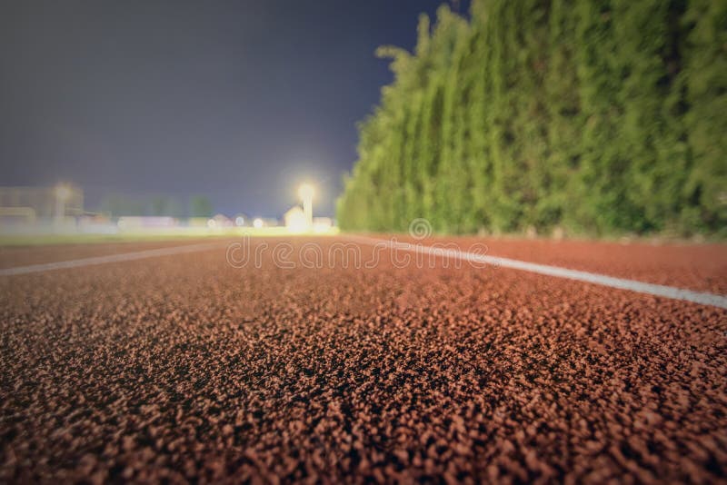 Running Track Close Up. Night Time Shallow Depth of Field. Sport Stock
