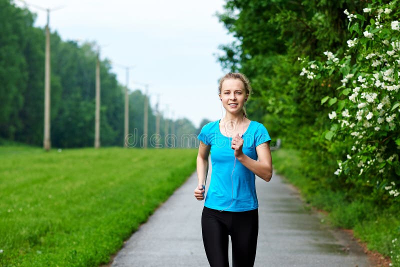 Running woman atletic spotsman training in the summer park. Outdoor fitness portrait