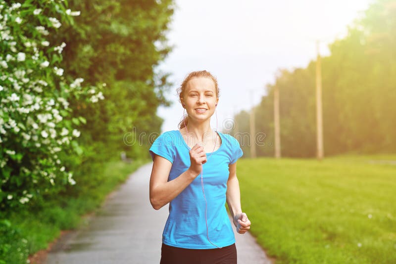 Running woman atletic spotsman training in the summer park. Outdoor fitness portrait