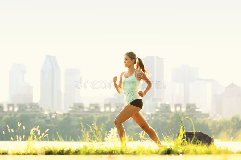 Young woman running in the nature. Healthy lifestyle and sport concepts.  Runner training in a urban area.The woman with runner on the street be  running for exercise. Stock Photo