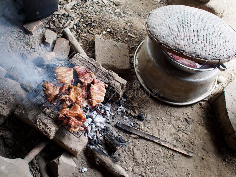 Rural chef in vintage homestay cooking fresh delicious grilled meats ribs and pork on charcoal gril. L with salt and traditional source at rural minimal kitchen stock photos Rural chef in vintage homestay cooking fresh delicious grilled meats ribs and pork on charcoal gril. L with salt and traditional source at rural minimal kitchen stock photos