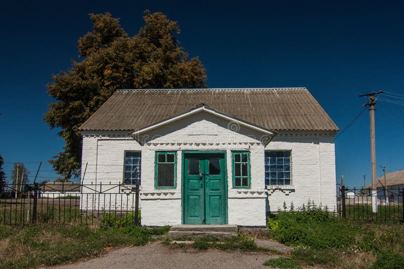 Rural house with green door in Parkhomivka