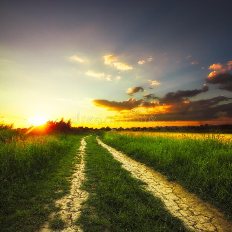 Field and Dirt Road To Sunset Stock Photo - Image of evening, dirt ...