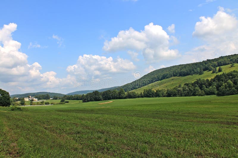 Landscape and cloudscape of a rural New York dairy farm in the summertime. Landscape and cloudscape of a rural New York dairy farm in the summertime