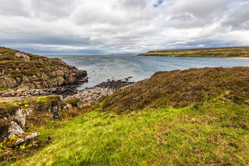 Landscape on the road to Red Point beach, Wester Ross. Rural views in wester ross with the ocean and a cloudy sky in the background stock photos Landscape on the road to Red Point beach, Wester Ross. Rural views in wester ross with the ocean and a cloudy sky in the background stock photos