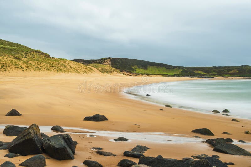 Landscape on the road to Red Point beach, Wester Ross. Rural views in wester ross with the red point beach and a cloudy sky in the background stock photo Landscape on the road to Red Point beach, Wester Ross. Rural views in wester ross with the red point beach and a cloudy sky in the background stock photo
