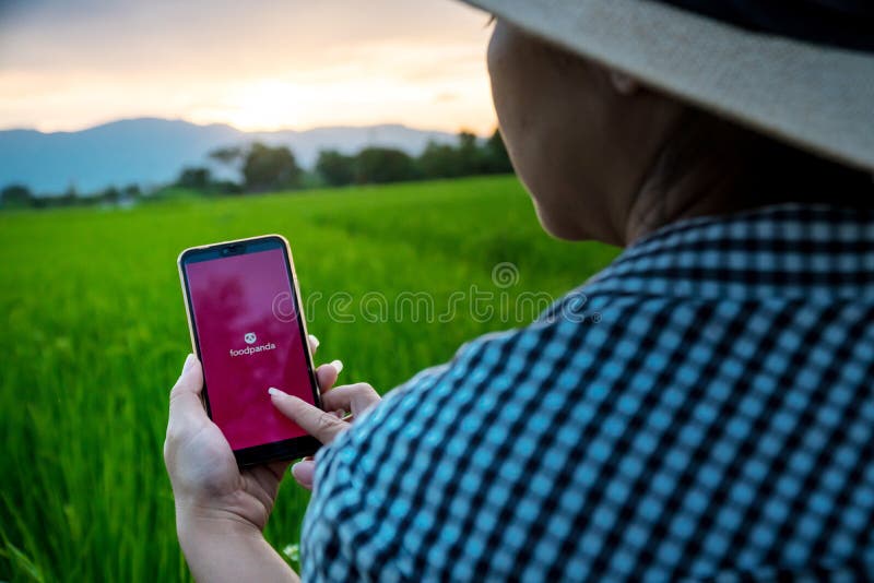 Chiang mai, Thailand - October 16, 2019: Rural women are using the Foodpanda application when she is in the fields