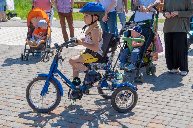 Rusia, Kazán - 31 De Mayo De 2019: Niño Discapacitado Con Gafas En Un Triciclo En Un DÃa Soleado Y Brillante. Viaje En Biciclet Foto editorial - Imagen de discapacitado, soleado: 157194656