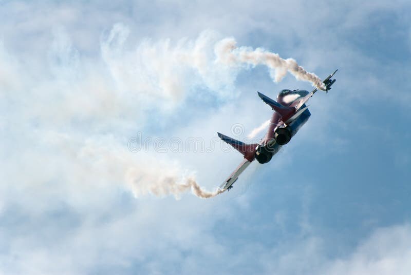 Russia. Zhukovski aviation salon. MAKS. MIG-29 OVT fighter performing aerobatic elements and ejecting thermal traps (salute). Russia. Zhukovski aviation salon. MAKS. MIG-29 OVT fighter performing aerobatic elements and ejecting thermal traps (salute)