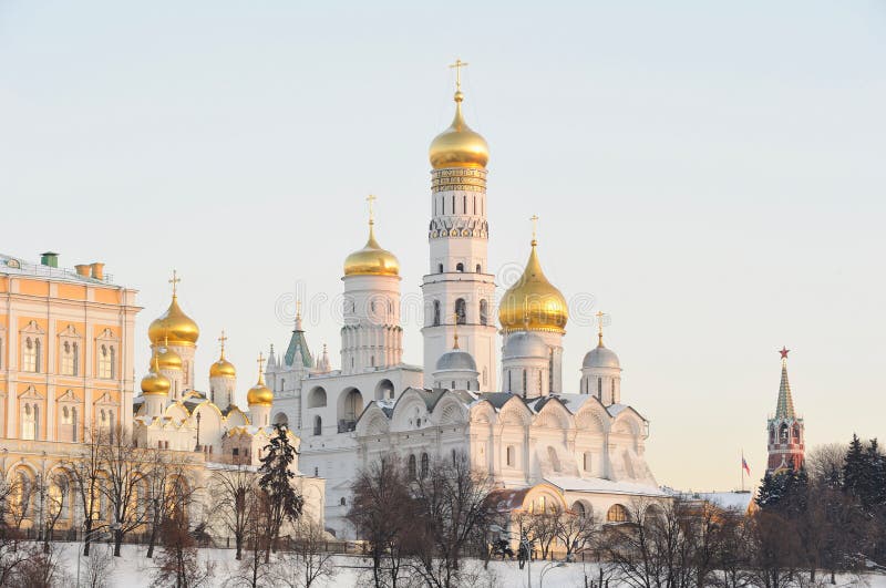 Russia. Ensemble of Moscow Kremlin. View on Kremlin cathedralas, wall and towers from Bolshoi Moskvoretsky bridge at a winter sunrise. Russia. Ensemble of Moscow Kremlin. View on Kremlin cathedralas, wall and towers from Bolshoi Moskvoretsky bridge at a winter sunrise