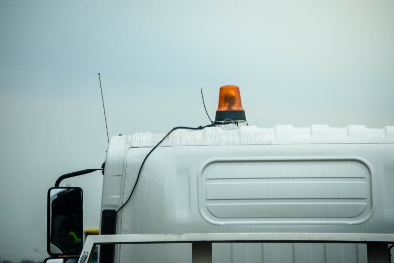 Russia Petersburg August 4, 2020: Tow truck in the city - rear view of the flashing light on the roof of the car. Russia Petersburg August 4, 2020: Tow truck in the city - rear view of the flashing light on the roof of the car