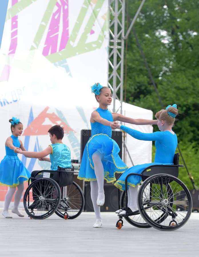 Children in wheelchairs are dancing on the stage. The fulcrum festival