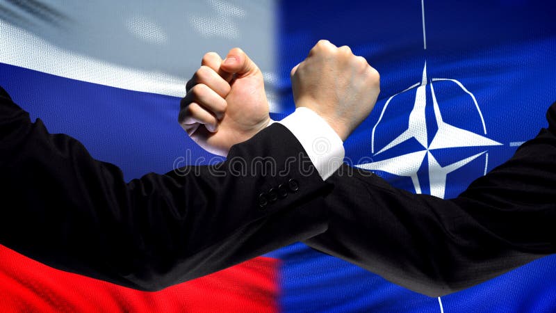 Russia vs NATO confrontation, countries disagreement, fists on flag background royalty free stock image Russia vs NATO confrontation, countries disagreement, fists on flag background royalty free stock image