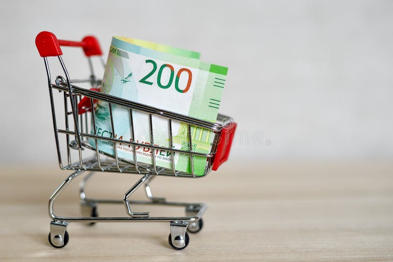 Russian money banknotes in a shopping trolley, online shopping concept royalty free stock image Russian money banknotes in a shopping trolley, online shopping concept royalty free stock image