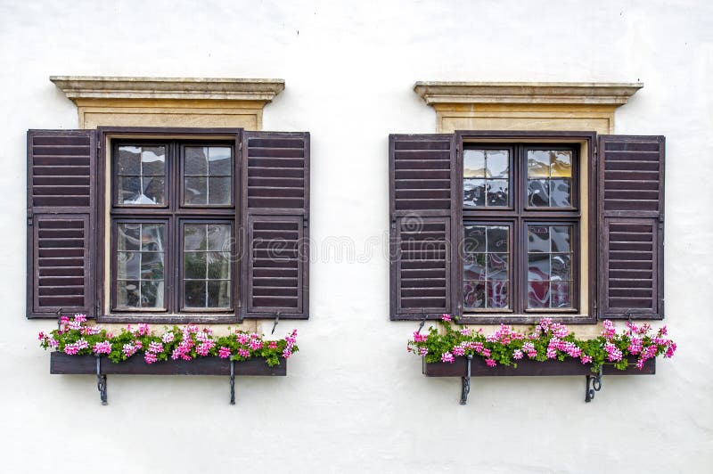 Twin flower windows in Rust, Burgenland, Austria by Neusiedler Lake. Twin flower windows in Rust, Burgenland, Austria by Neusiedler Lake