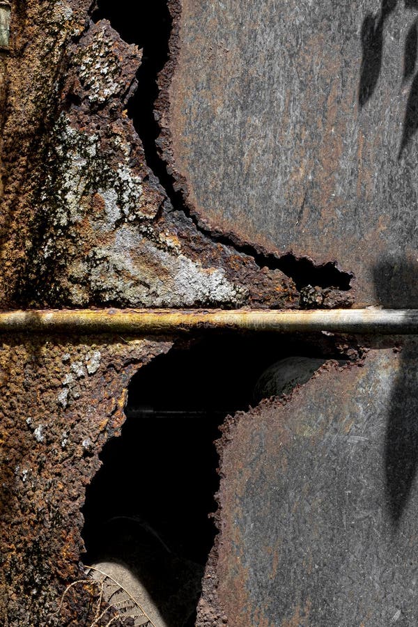 Rust Covered Metal Door Panel with Rod Background Texture Stock Photo