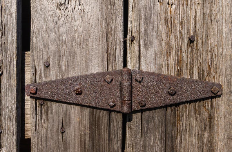 The rusted vintage hinge on the barn door. The rusted vintage hinge on the barn door.