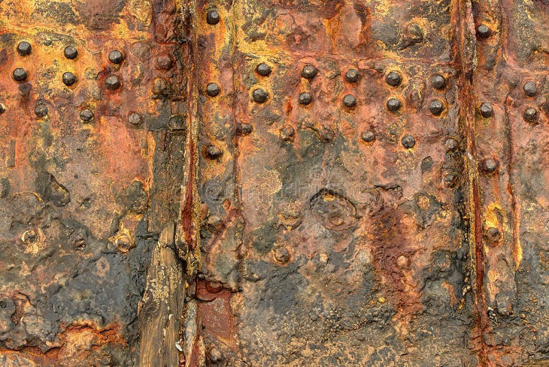 Rusted riveted steel hull. Abstract, background.