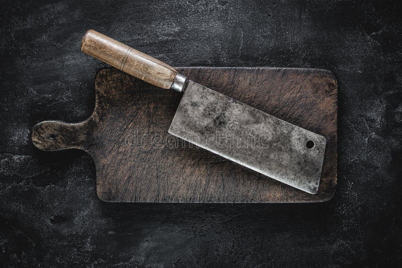 Rustic Cutting Board and Meat Cleaver on Dark Background Stock Photo