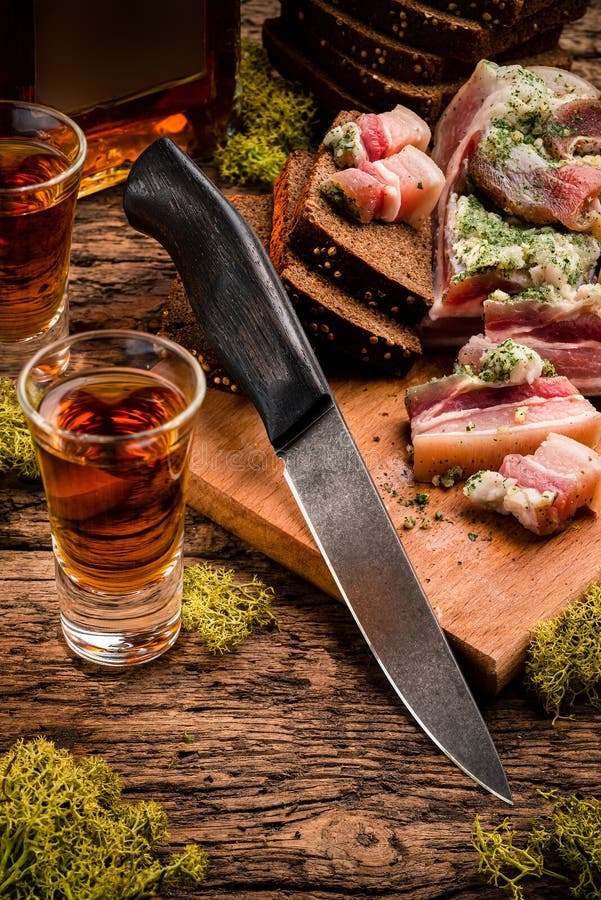 Rustic Dinner Board with Bread, Cold Meat, Hunting Knife Stock Image
