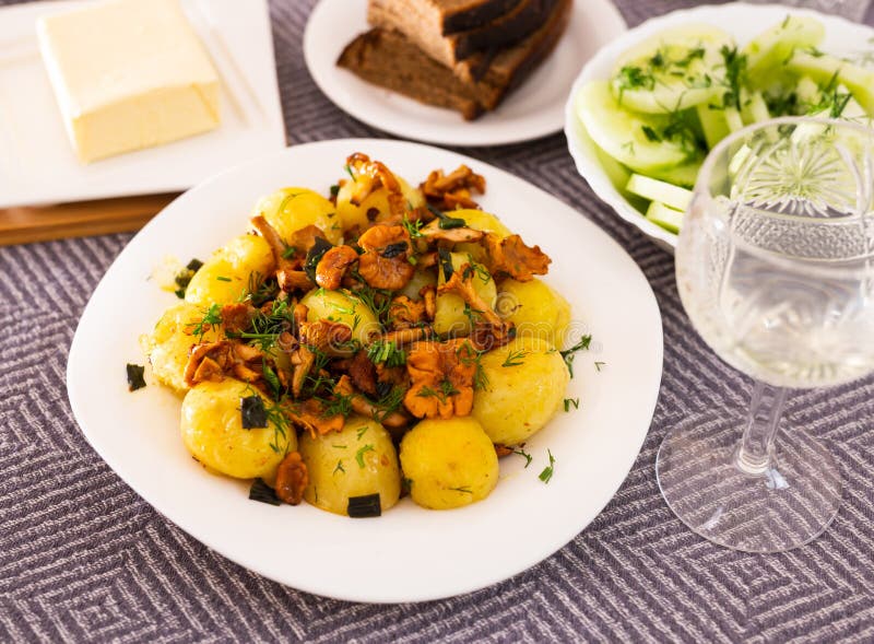 Rustic Dish. Fried Potatoes with Chanterelle Mushrooms with Herbs Stock