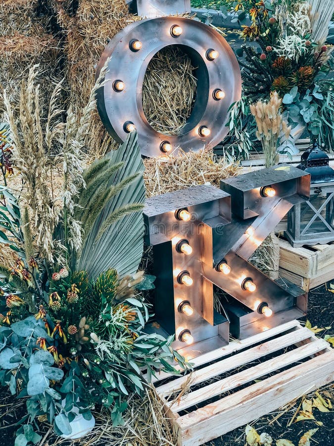 Rustic fall decor with illuminated letters in a festive autumn setting stock images