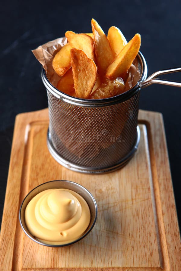 Rustic French Fries with Cheese Sauce. Appetizer for Beer. Stock Photo