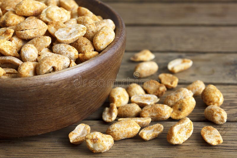 Rustic Spicy Dry Roasted Peanuts in Rustic Wood Bowl. Stock Image