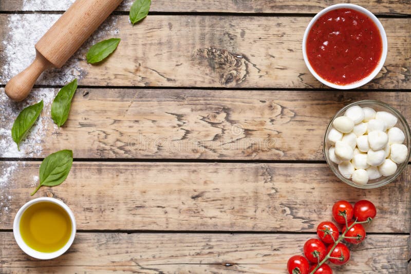 Rustic traditional Italian food background with empty copy design space on aged wooden texture table. Basil, olive oil stock photography