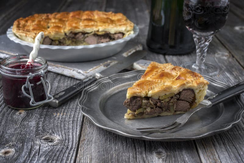 Rustic Venison Pie with cranberry relish on a pewter plate