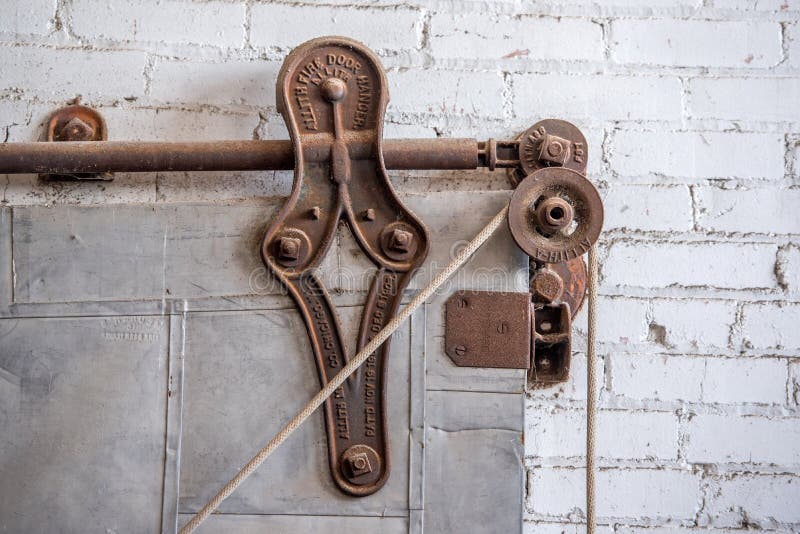 Rustic vintage pulley on metal industrial door