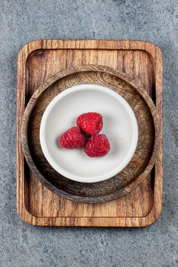 Rustic wooden plates on a concrete background, showing a mix of freshly picked berries. royalty free stock image Rustic wooden plates on a concrete background, showing a mix of freshly picked berries. royalty free stock image