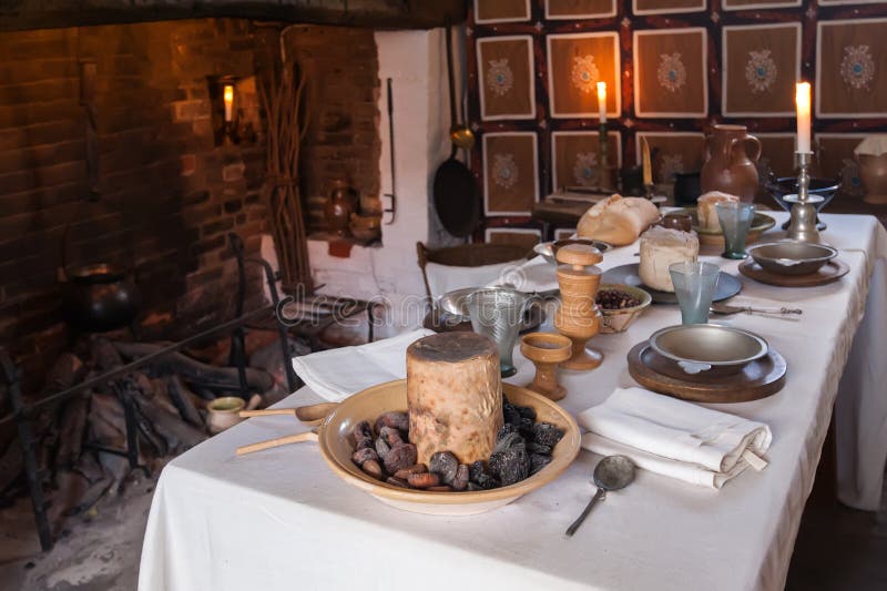 Interior of an old country house with fireplace and rustic table set for a breakfast. Interior of an old country house with fireplace and rustic table set for a breakfast.