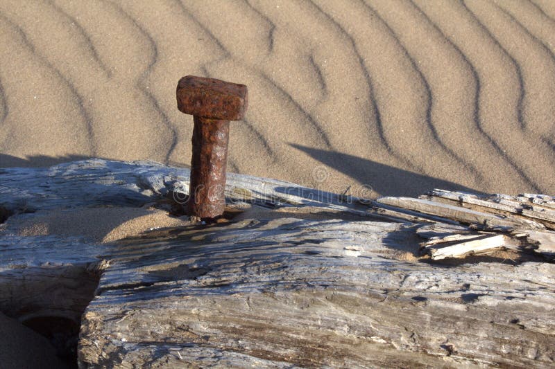 A rusting bolt in a decaying wooden beam. royalty free stock photography A rusting bolt in a decaying wooden beam. royalty free stock photography